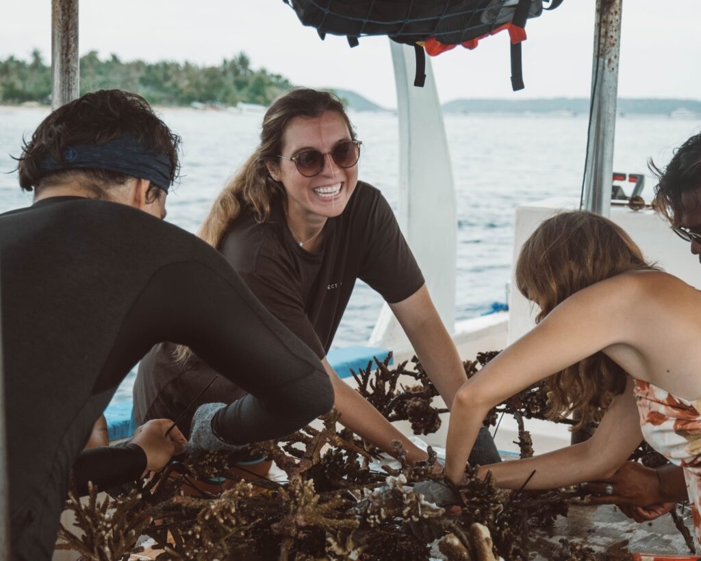 Participants attaching coral to restoration structures during marine conservation courses in Bali
